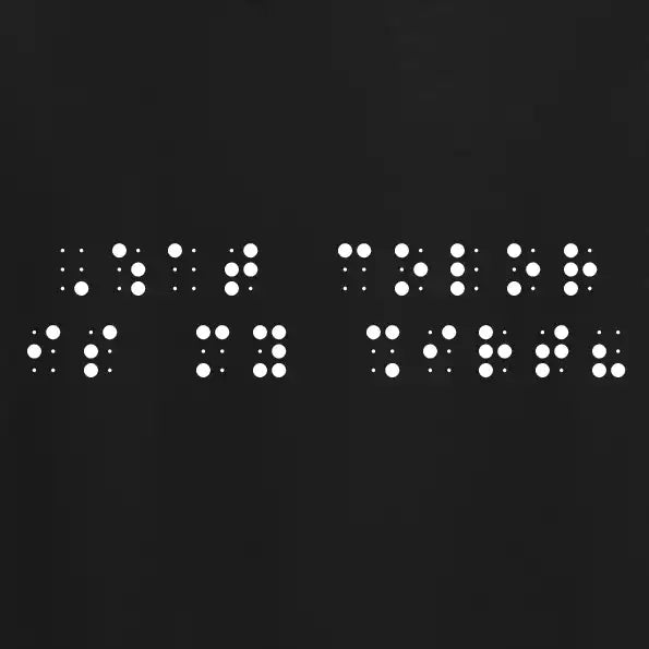 "What color is my shirt?" printed in white Grade 2 braille across the chest of a black t-shirt.