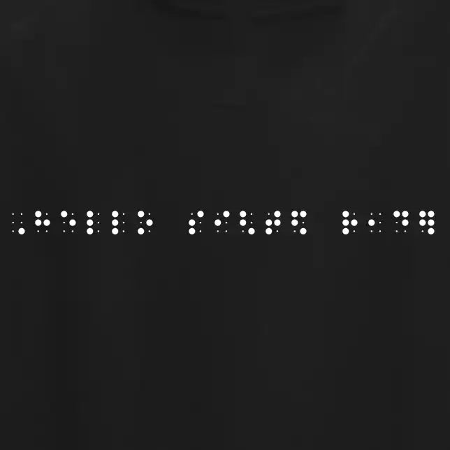 "Hello sighted reader" printed in white Grade 2 braille across the chest of a black t-shirt.